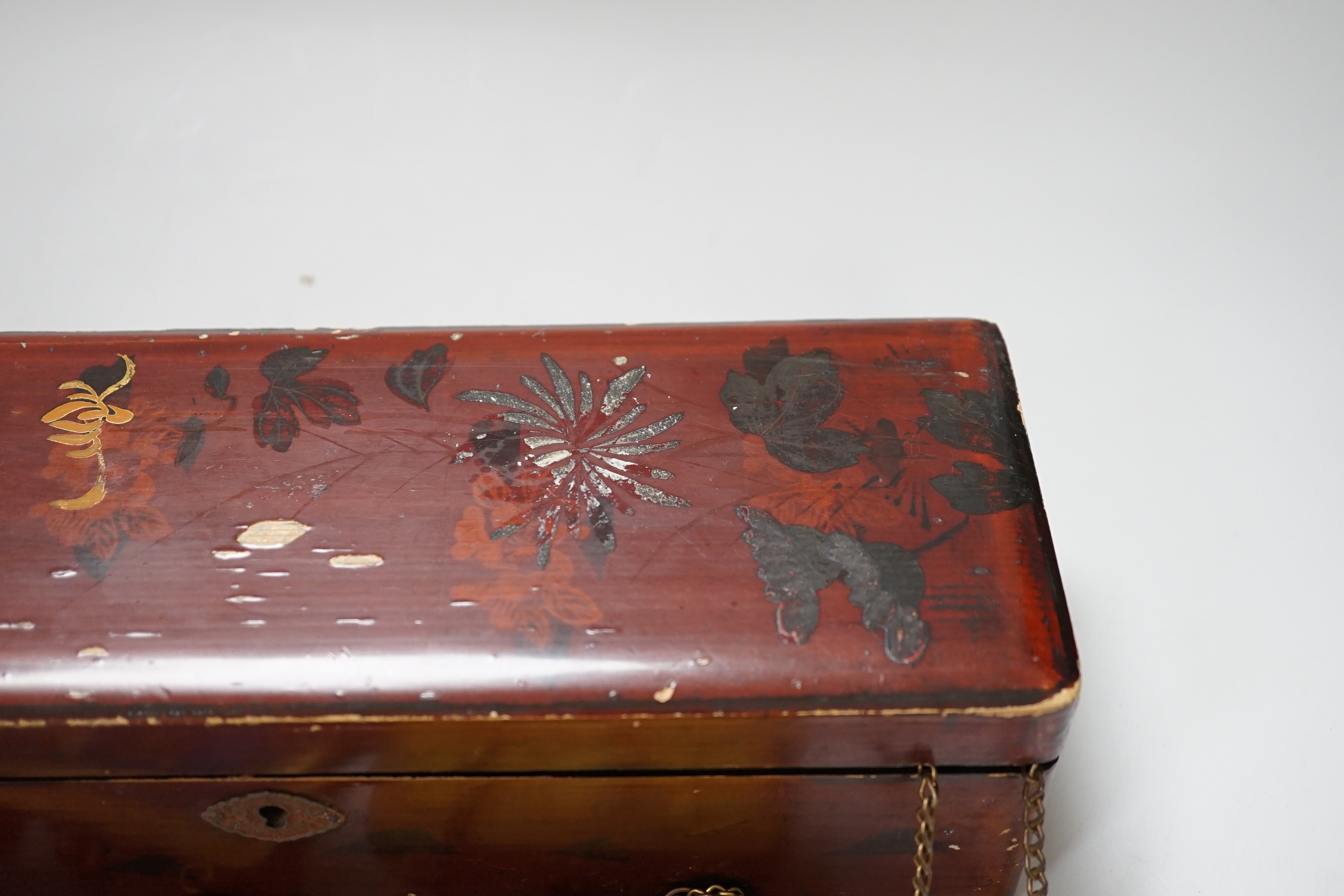 A lacquer box of Chinese embroidered purses and embroideries.